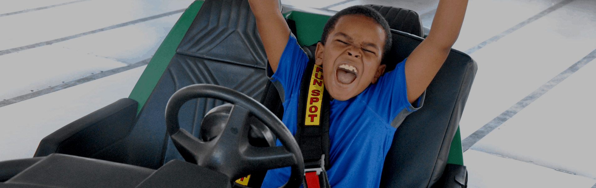 Boy cheering while on go-kart